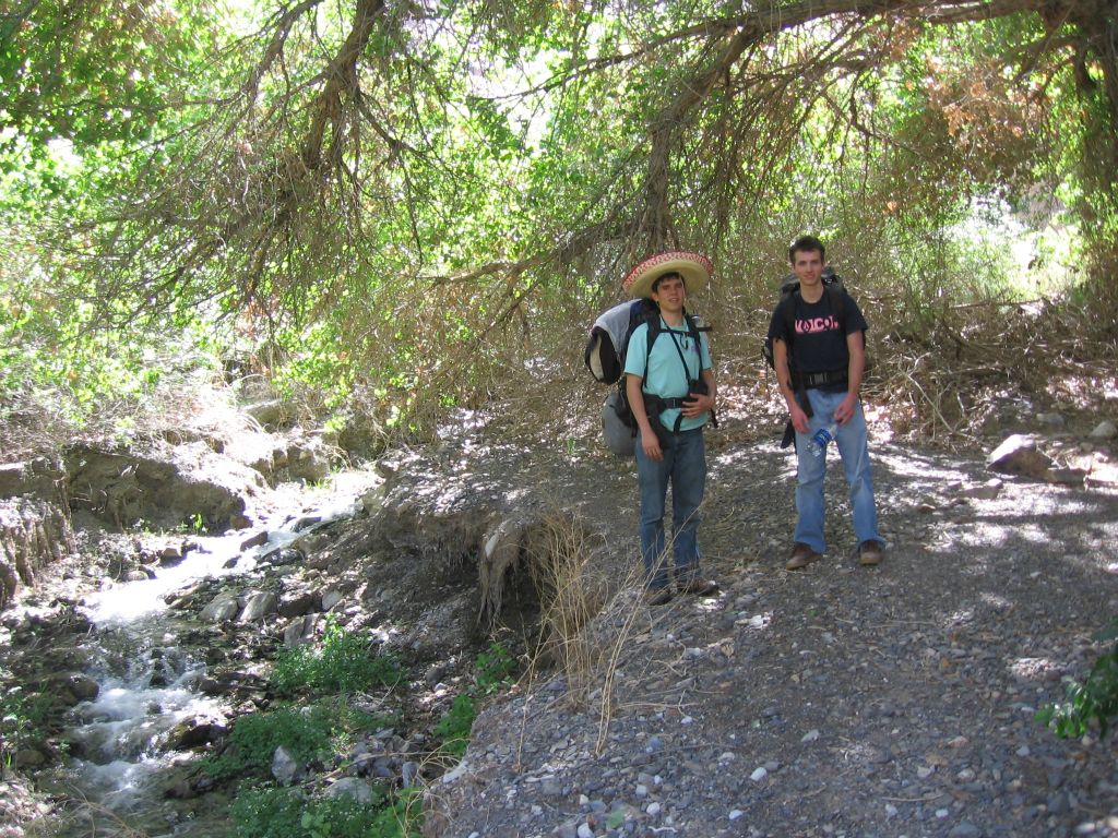 Rob and Josh catching their breath and resting under the shade of some trees: